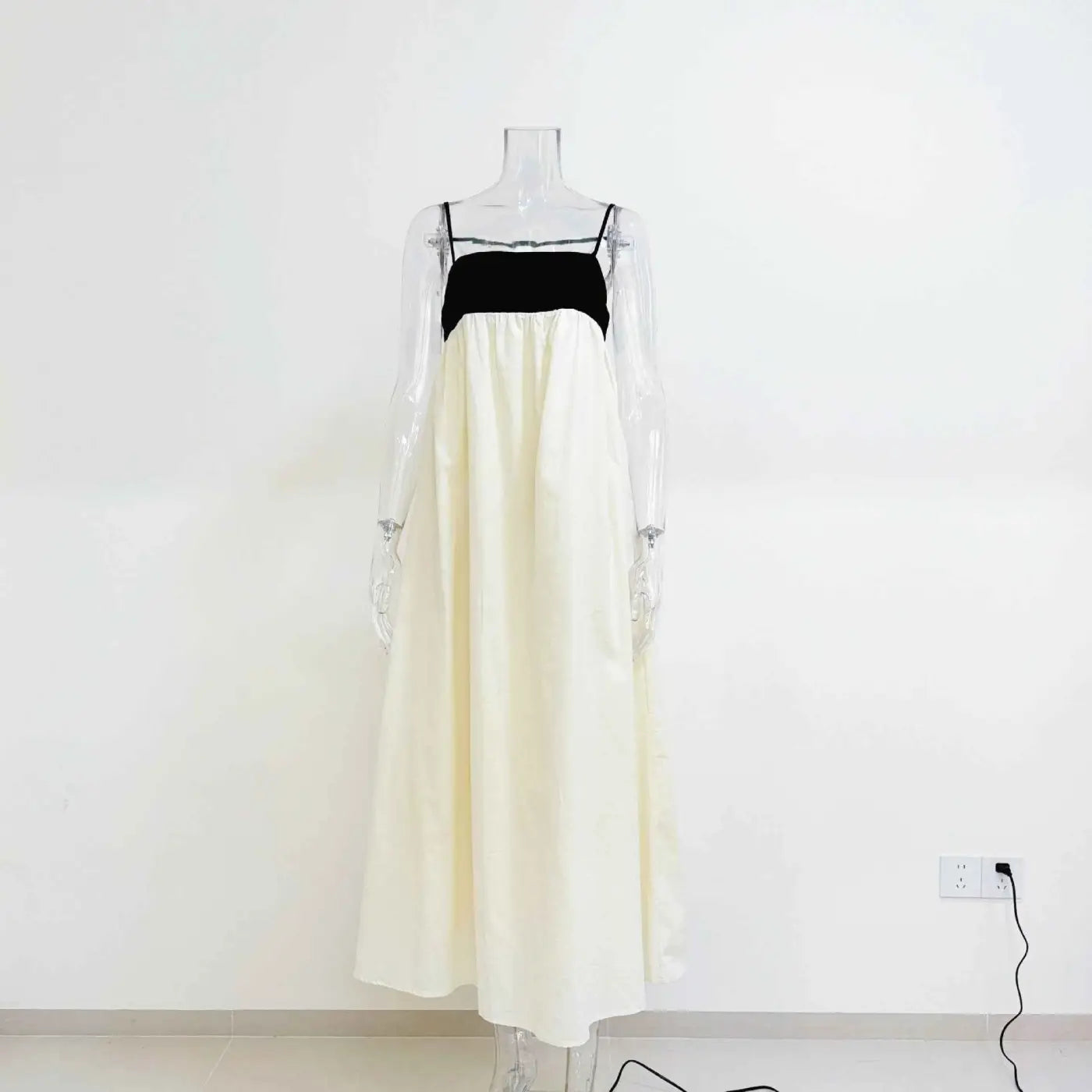 Women’s casual cotton linen sleeveless off-white maxi dress with black velvet bodice displayed on clear mannequin Beige