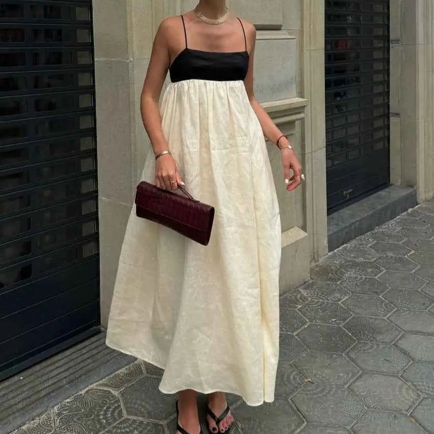 A deep burgundy leather clutch with a textured surface complements the women’s casual cotton linen sleeveless dress