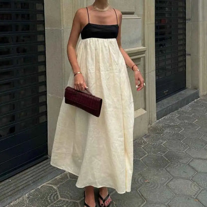 A deep burgundy leather clutch with a textured surface complements the women’s casual cotton linen sleeveless dress