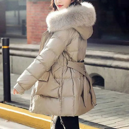 Beige women’s slim-fit padded down jacket with plush light gray fur-lined hood and matching belt silk cotton filler