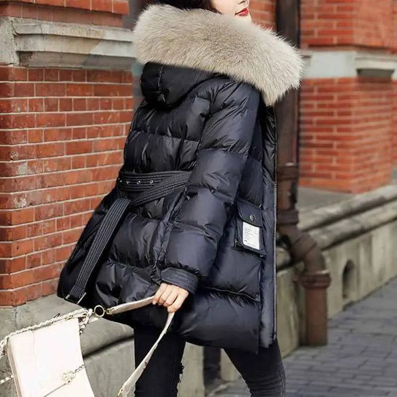 Women’s slim-fit padded down jacket in black with plush light gray fur-lined hood and silk cotton filler belt